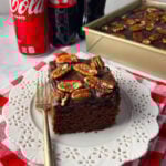 Old fashioned coca cola cake slice on a white plate.