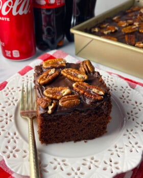 Old fashioned coca cola cake slice on a white plate.