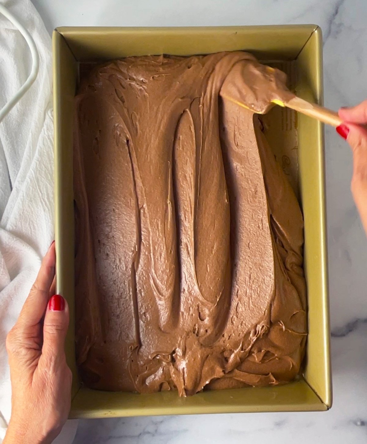 Chocolate coca cola cake batter in oblong pan.