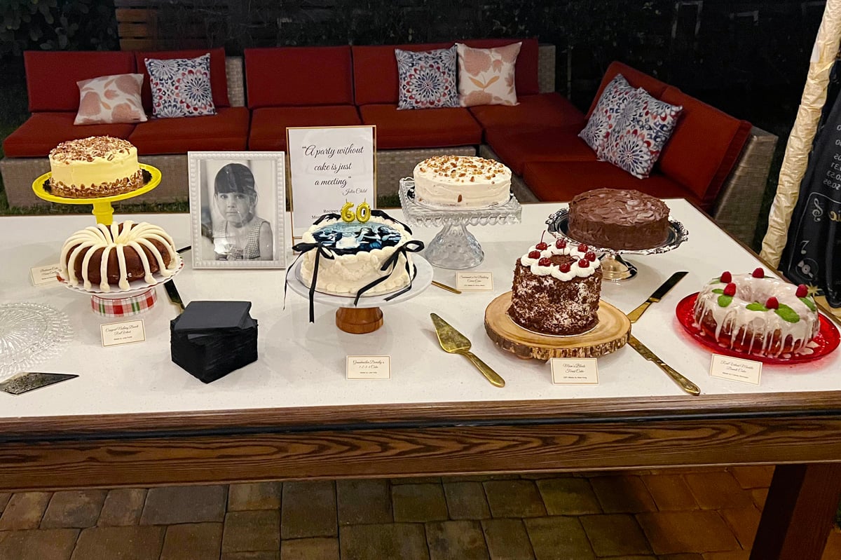 Cake table with seven birthday cakes.