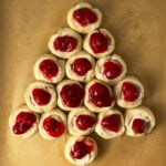 Cherry danish shaped like Christmas tree on baking pan ready to bake.
