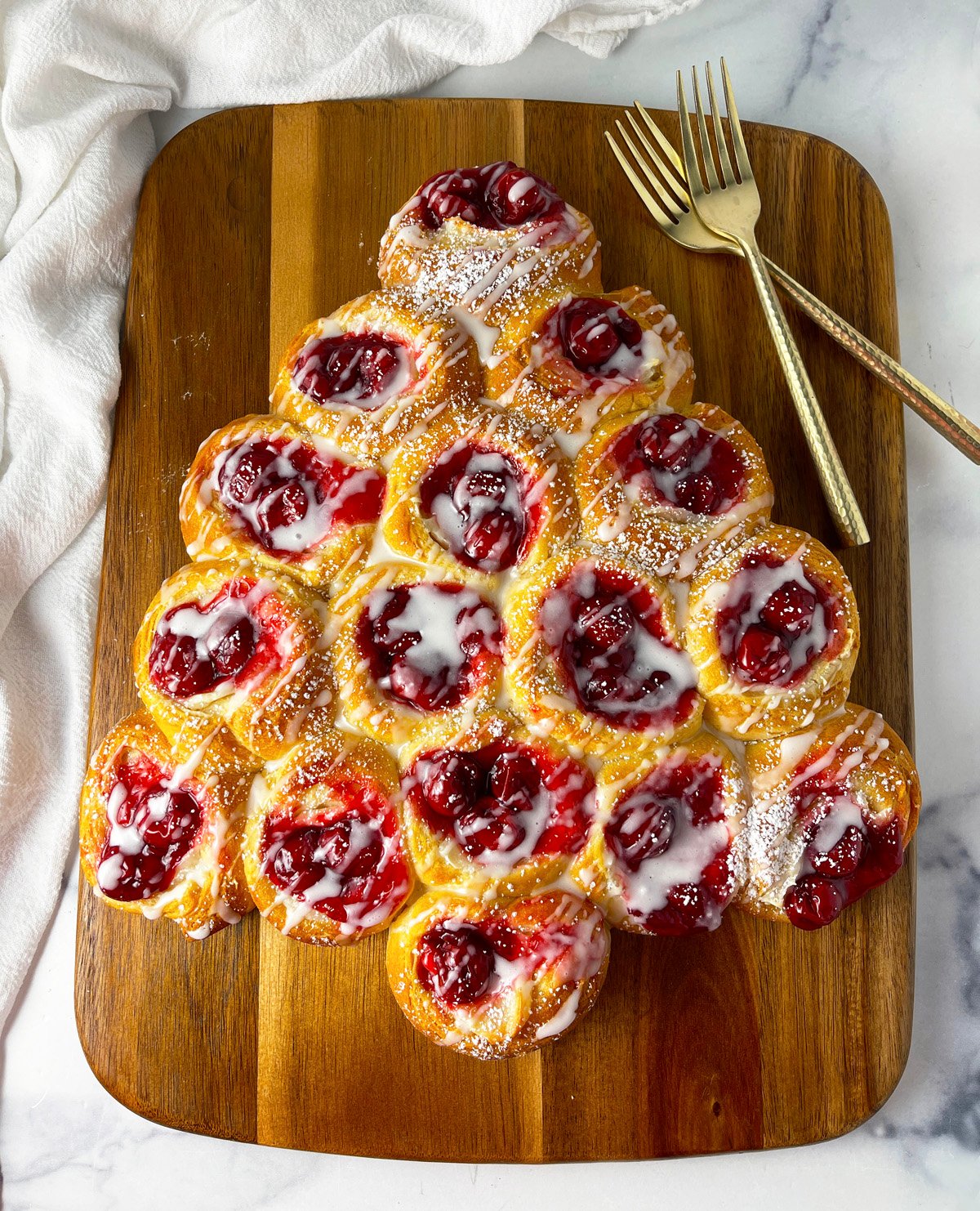 Cherry danish shaped like a Christmas tree for the holidays.