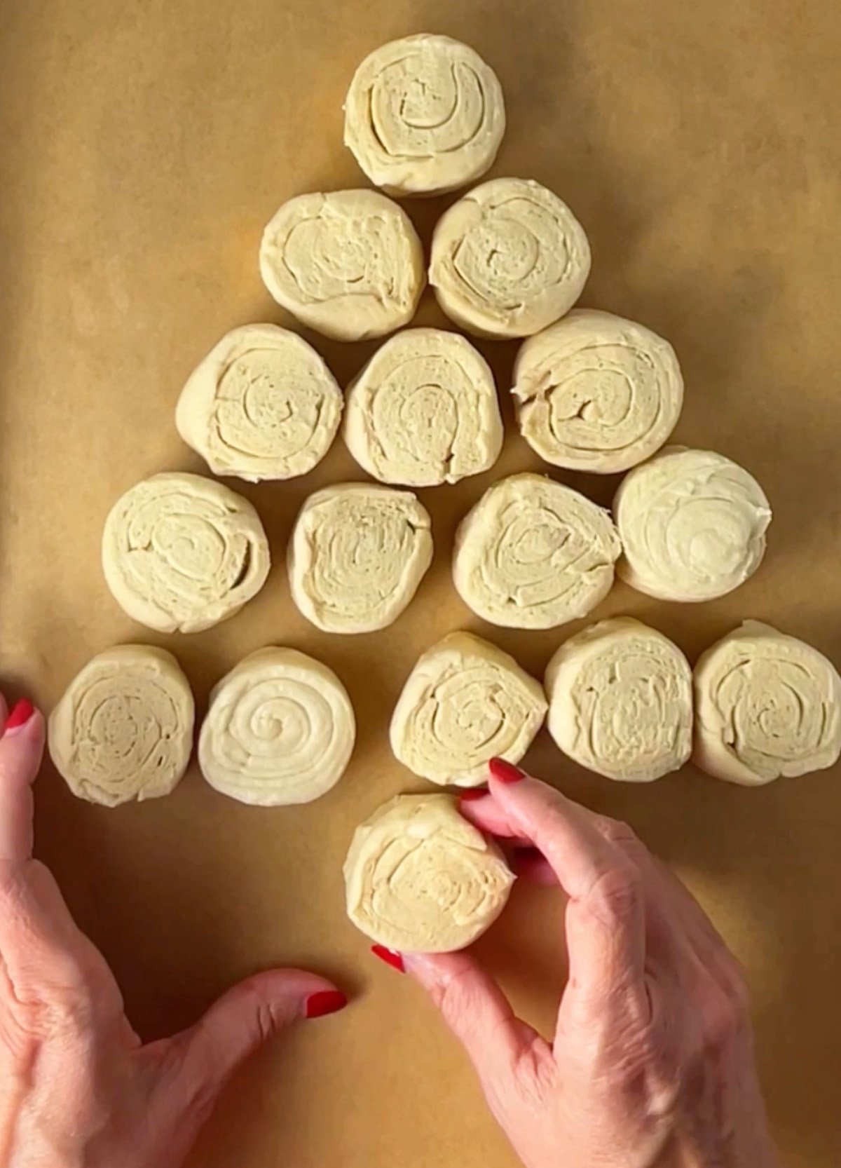 Crescent dough rolls arranged in shape of a tree on pan.
