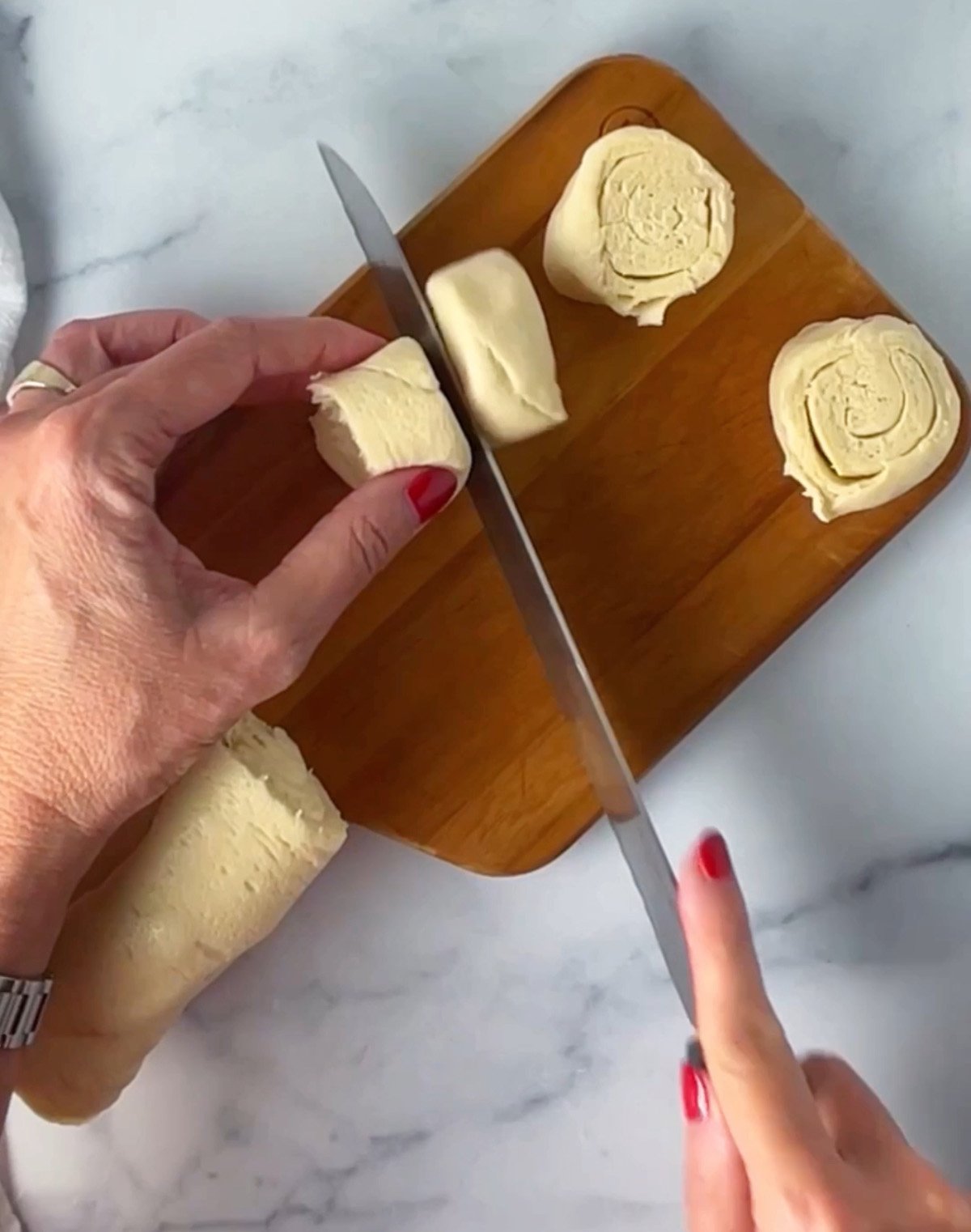 Preparing crescent dough into disks to create Christmas tree shape.