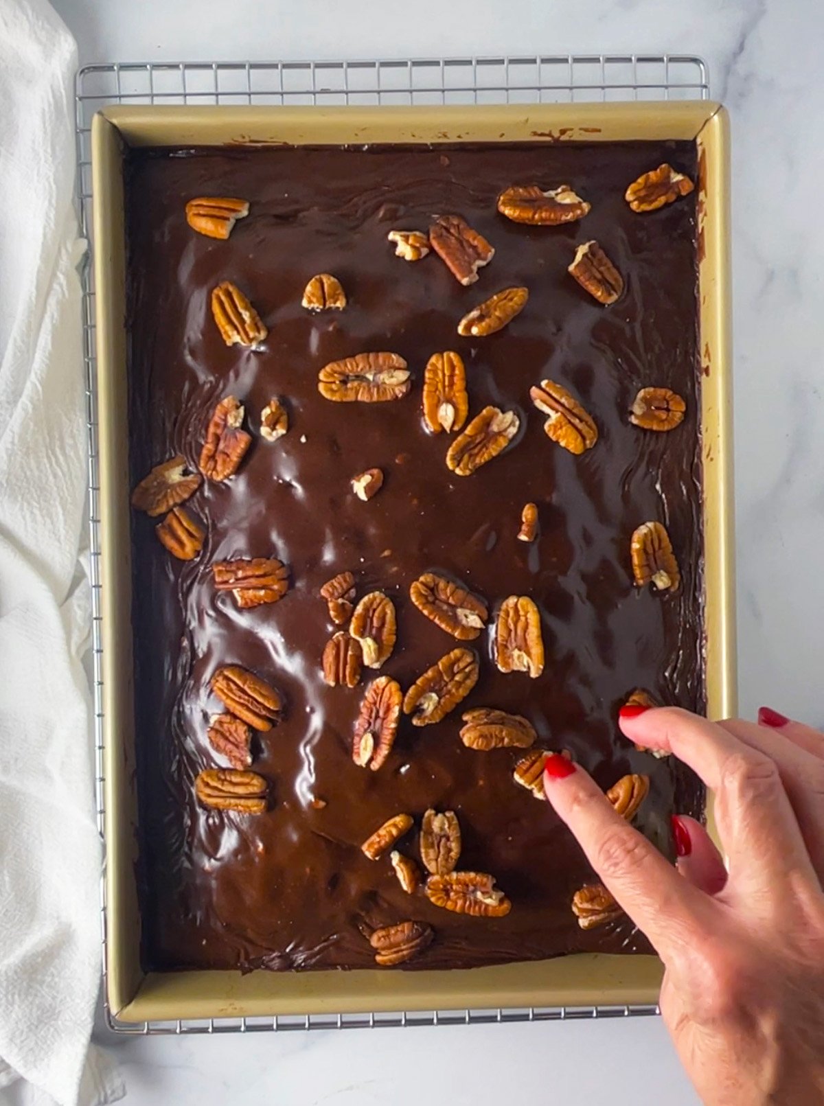 Old fashioned coca cola cake with boiled chocolate frosting and pecans.