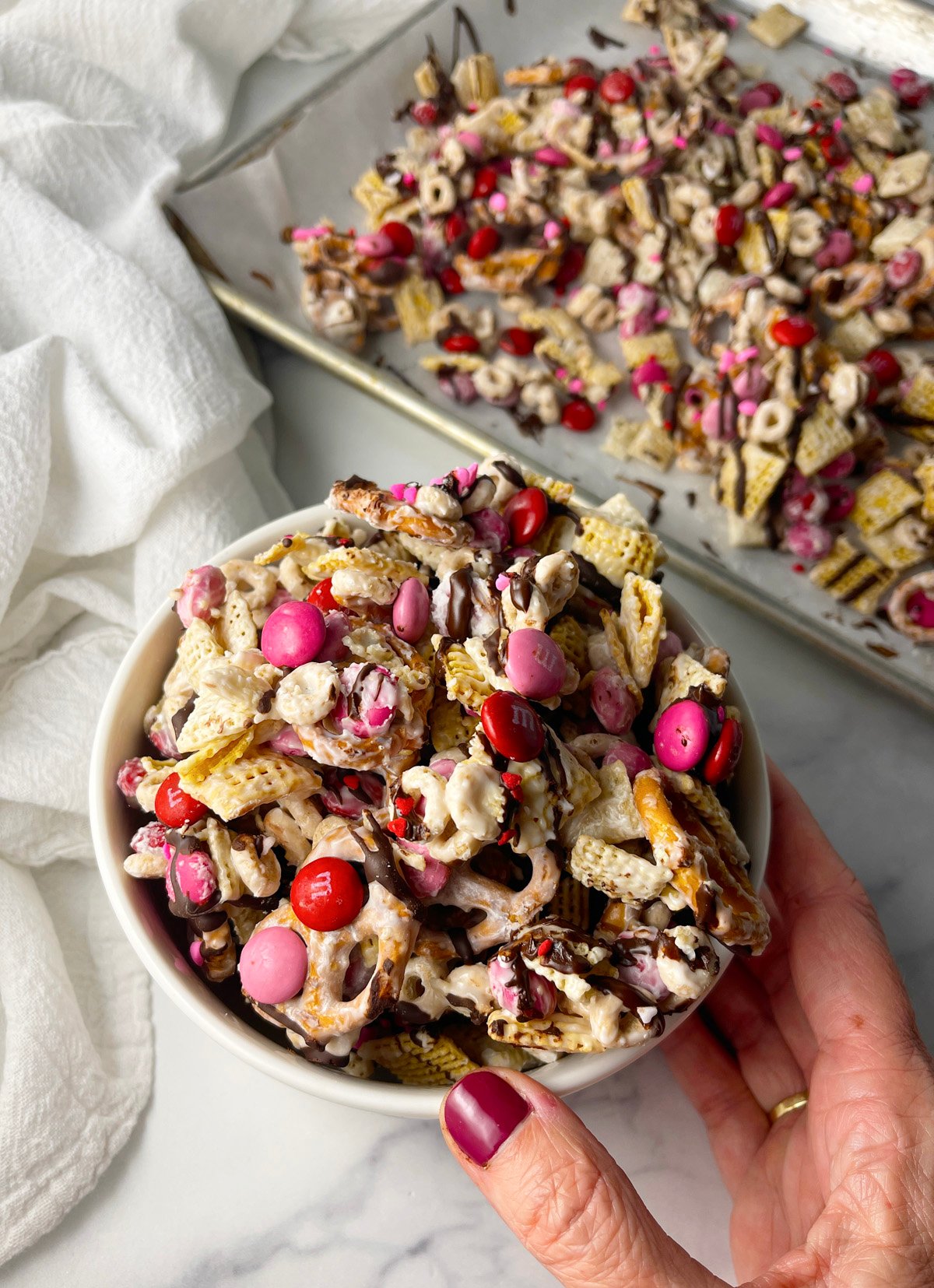 White bowl of finished valentine snack mix.