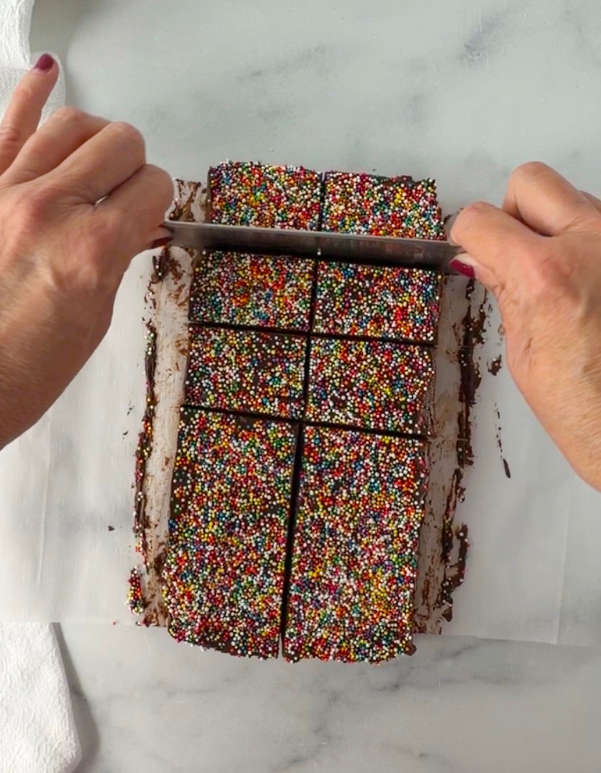 Cutting fudge into serving sizes or twelve rectangular pieces.