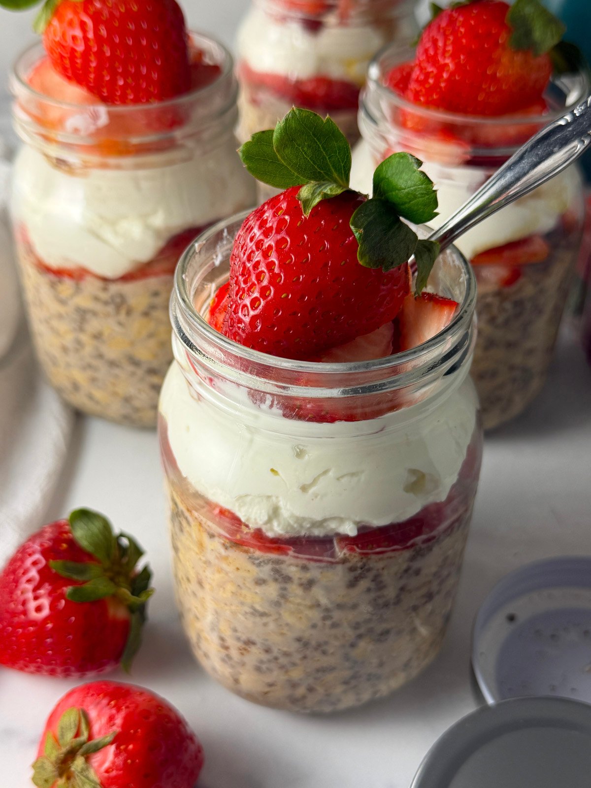 High protein overnight oats in mason jars with strawberries.