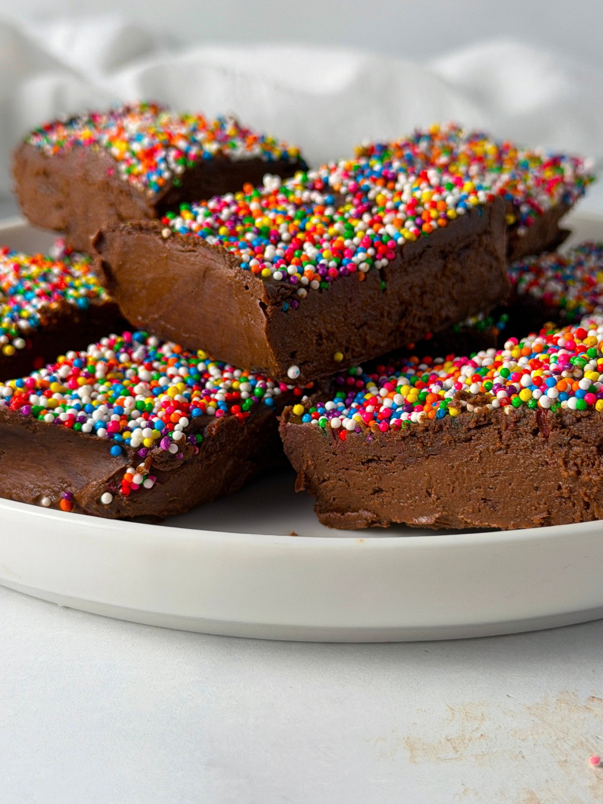 The best protein fudge with sprinkles on a white plate.