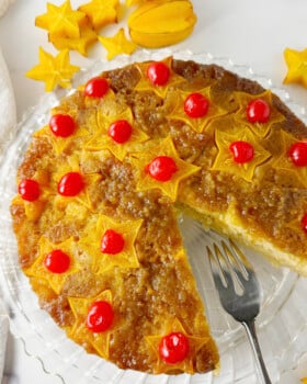 Star fruit upside down cake with slice taken out.