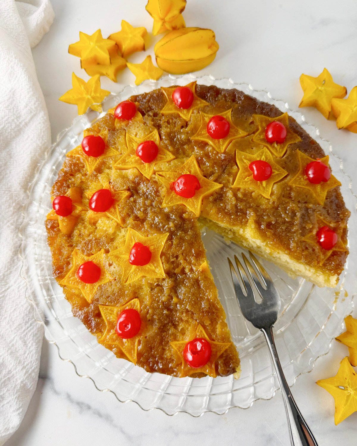 Star fruit upside down cake with cherries on top.