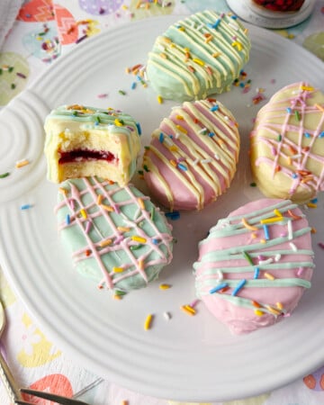 Egg shaped petits fours for Easter on white plate.