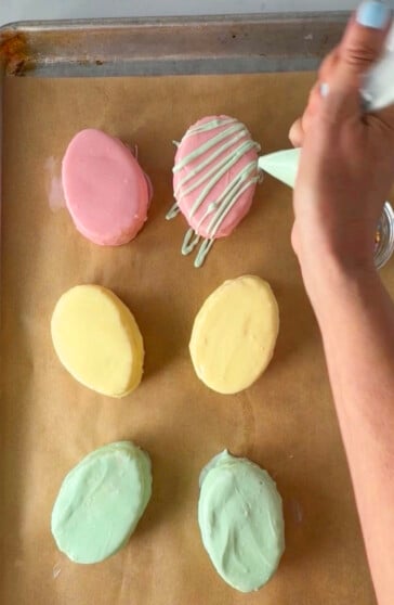Decorating Easter egg petits fours.