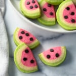 Slice and bake watermelon sugar cookies on a white plate.