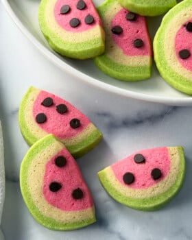 Slice and bake watermelon sugar cookies on a white plate.