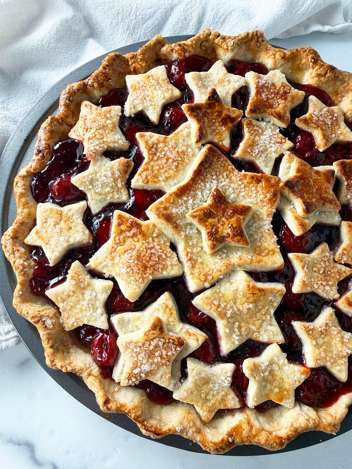Pretty cherry pie with pastry stars on top.