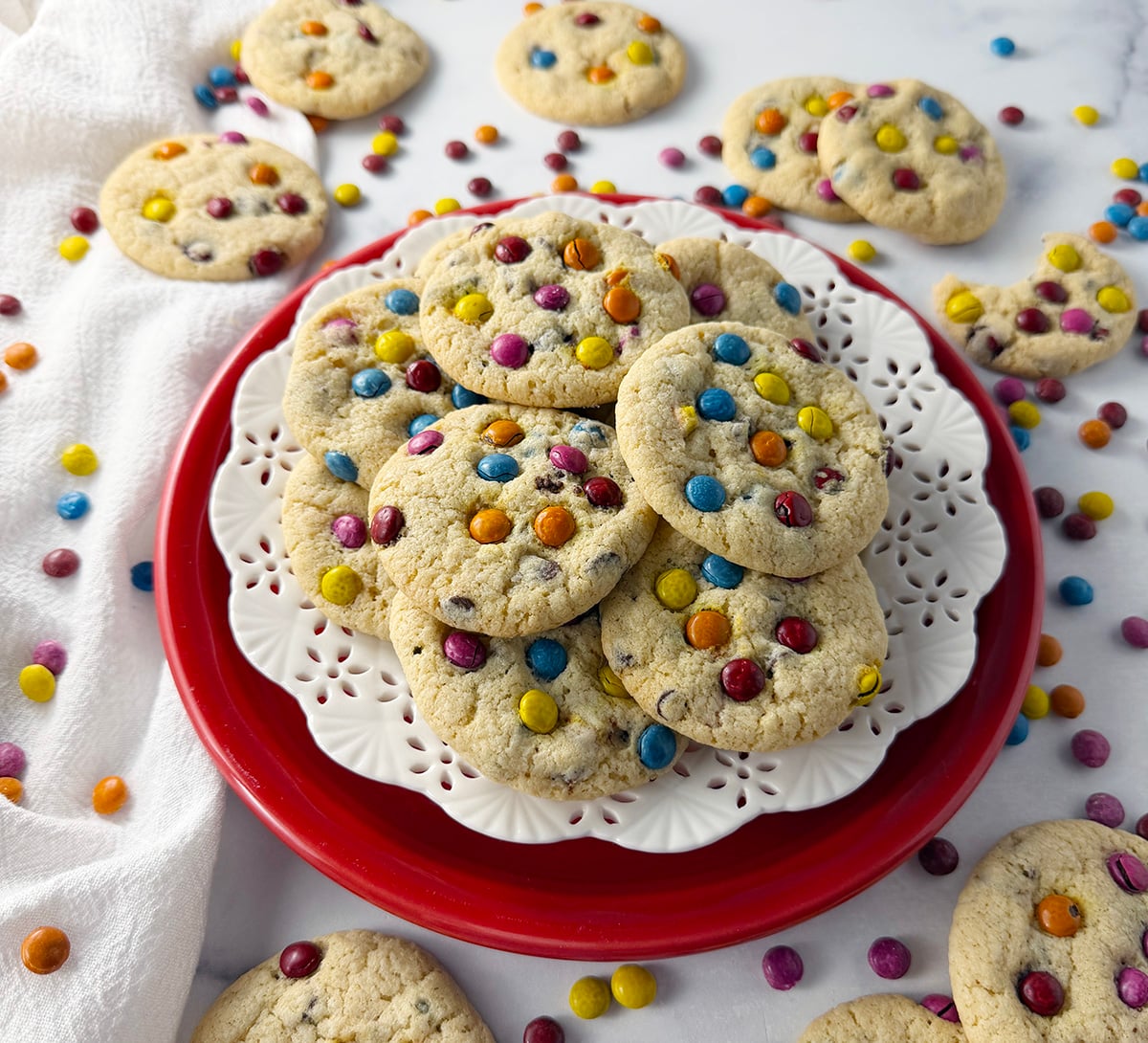 Gluten free chocolate chip cookies with rainbow mini pieces on a red plate.