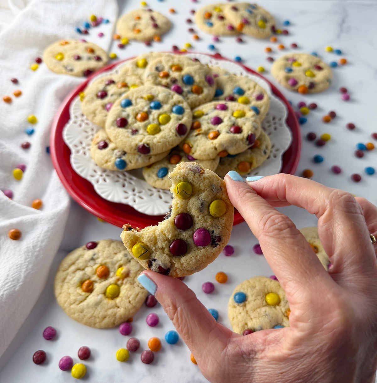 Gluten free chocolate chip m&m style cookies on a plate.
