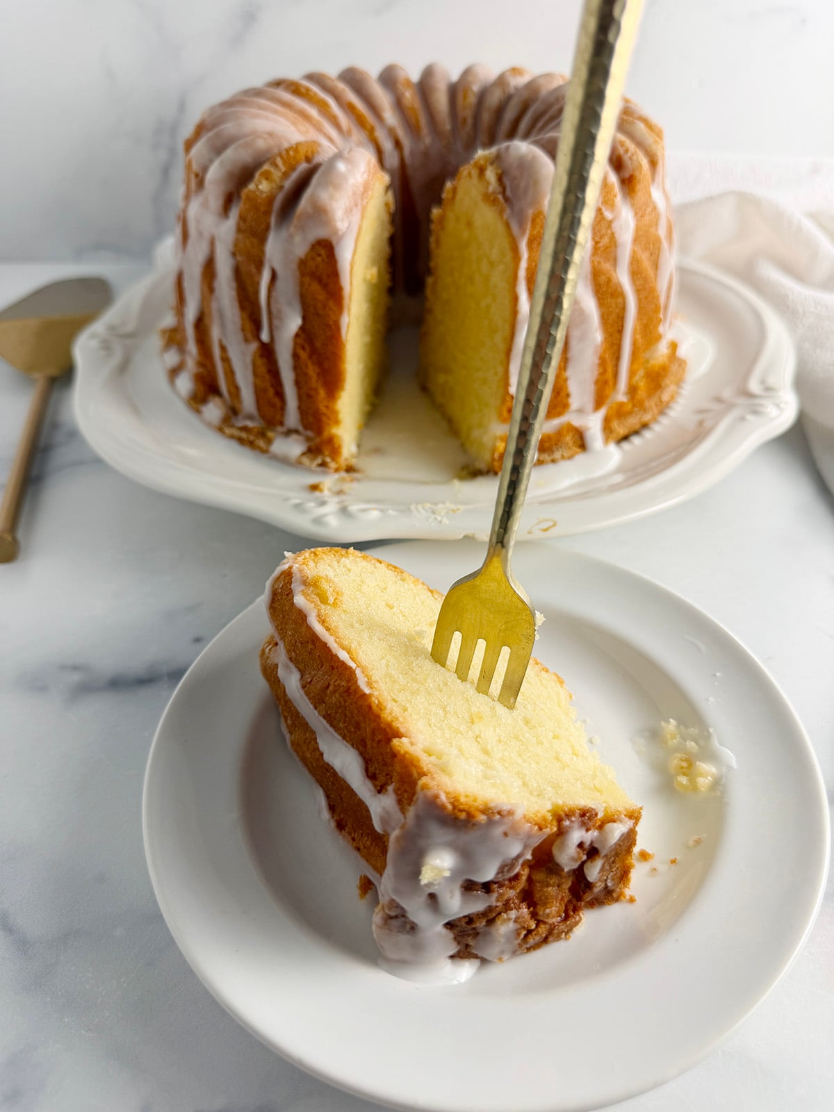 Sliced 7-up Bundt cake with serving on plate.