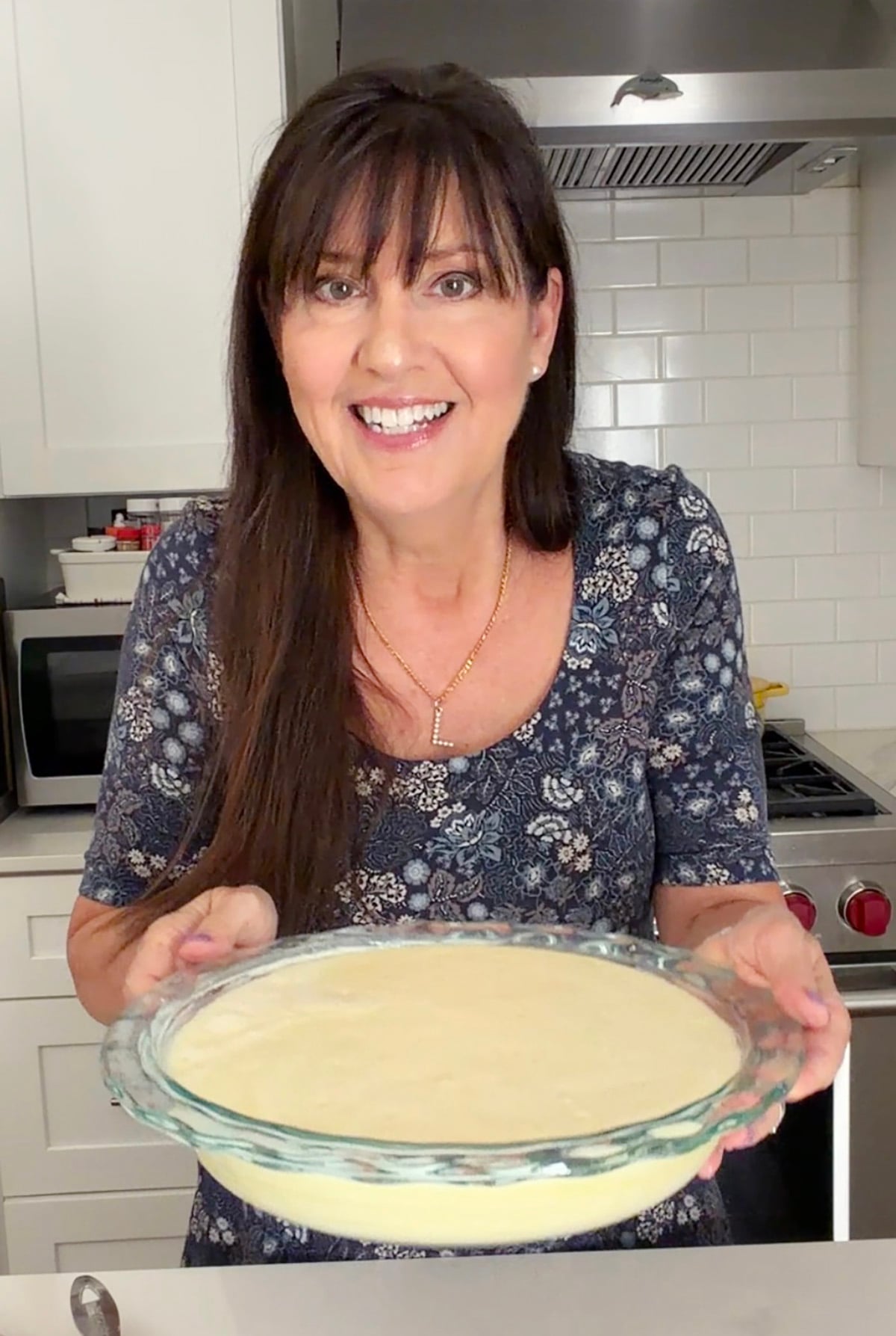 Mom Loves Baking in person, holding her pie that's ready to bake.