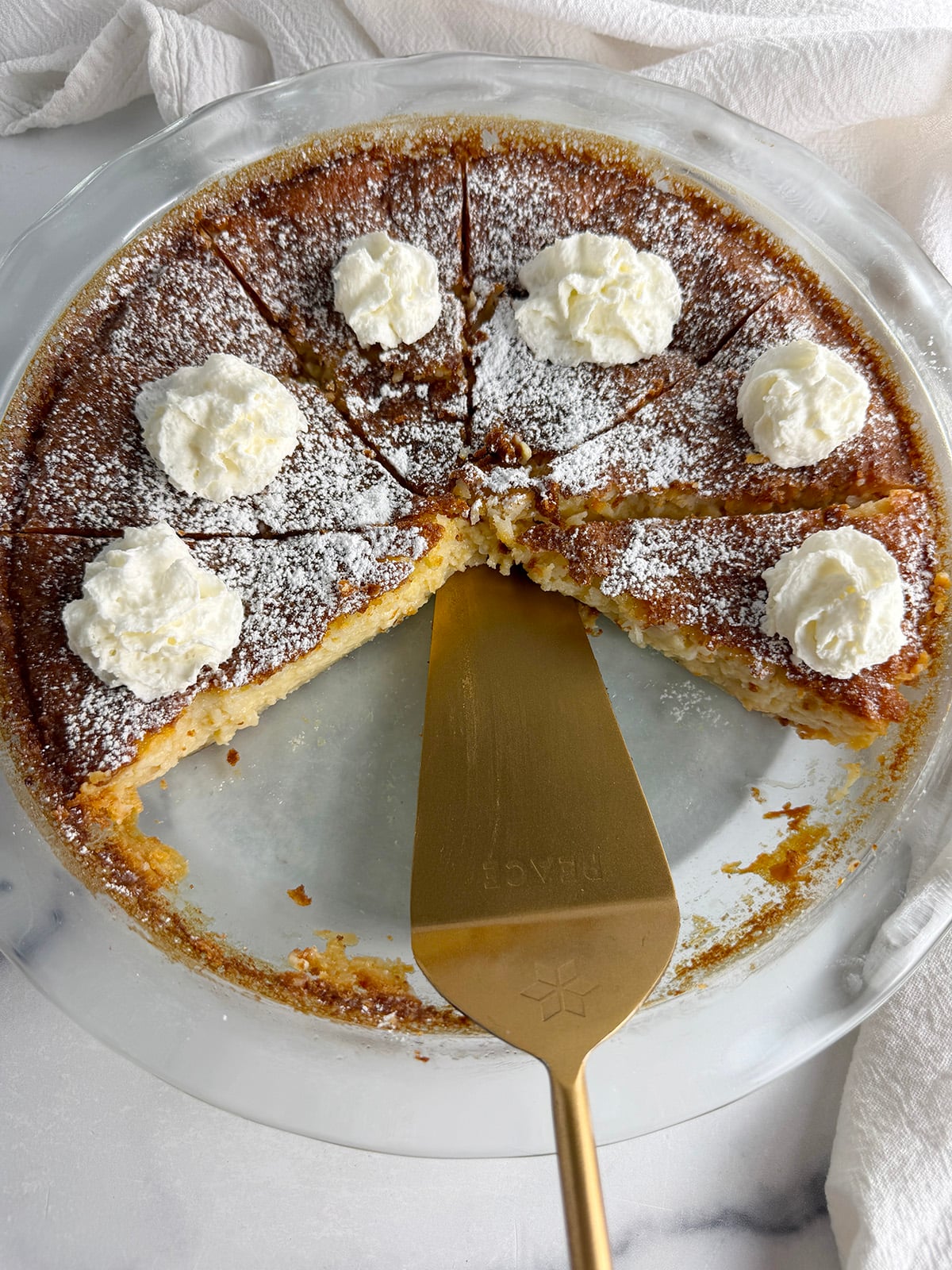 Coconut custard pie with whipped cream.