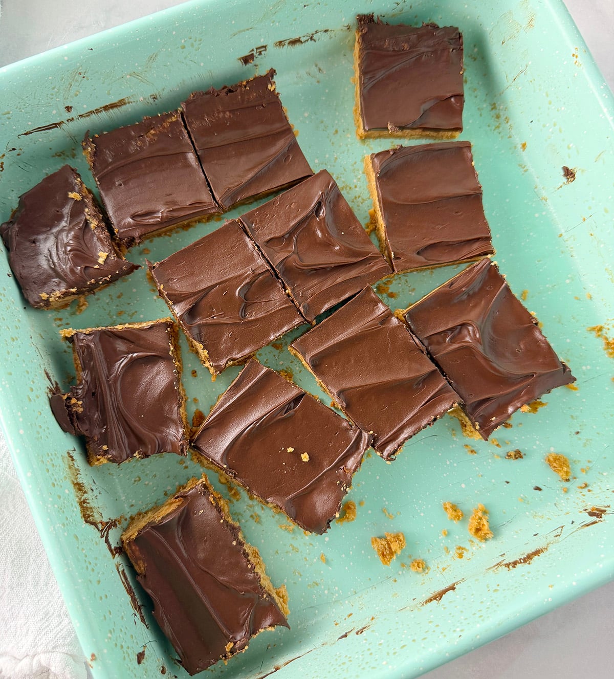 Chocolate peanut bars in squares in pan.