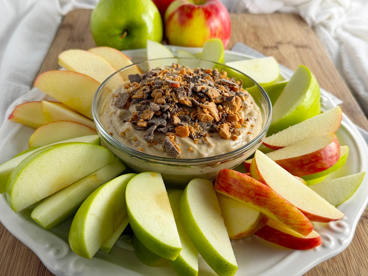 The best apple dip on a platter with sliced apples.