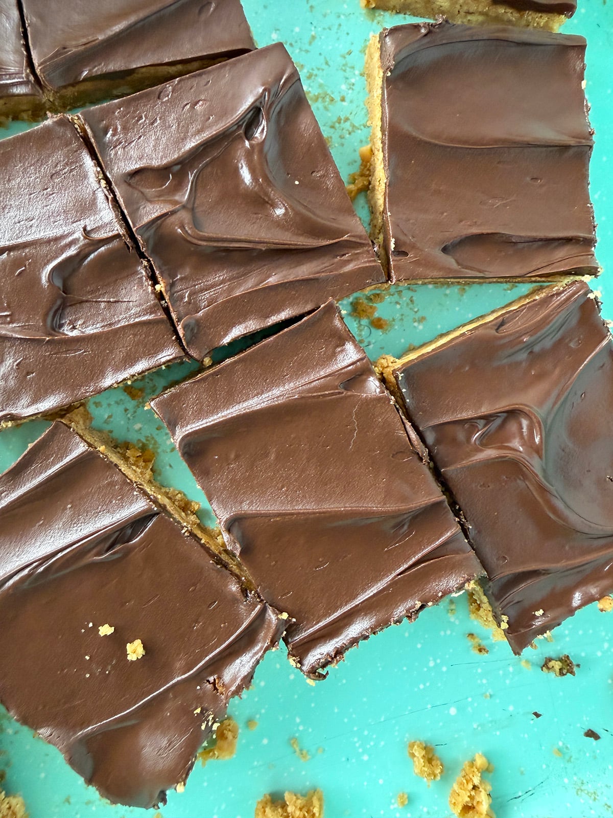 Glossy swirls of chocolate frosting on peanut bars.
