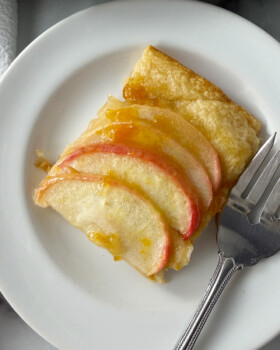 Grandmas easy apple tart served on a small white plate.