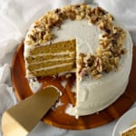 Autumn gold pumpkin cake on a wooden cake platter.