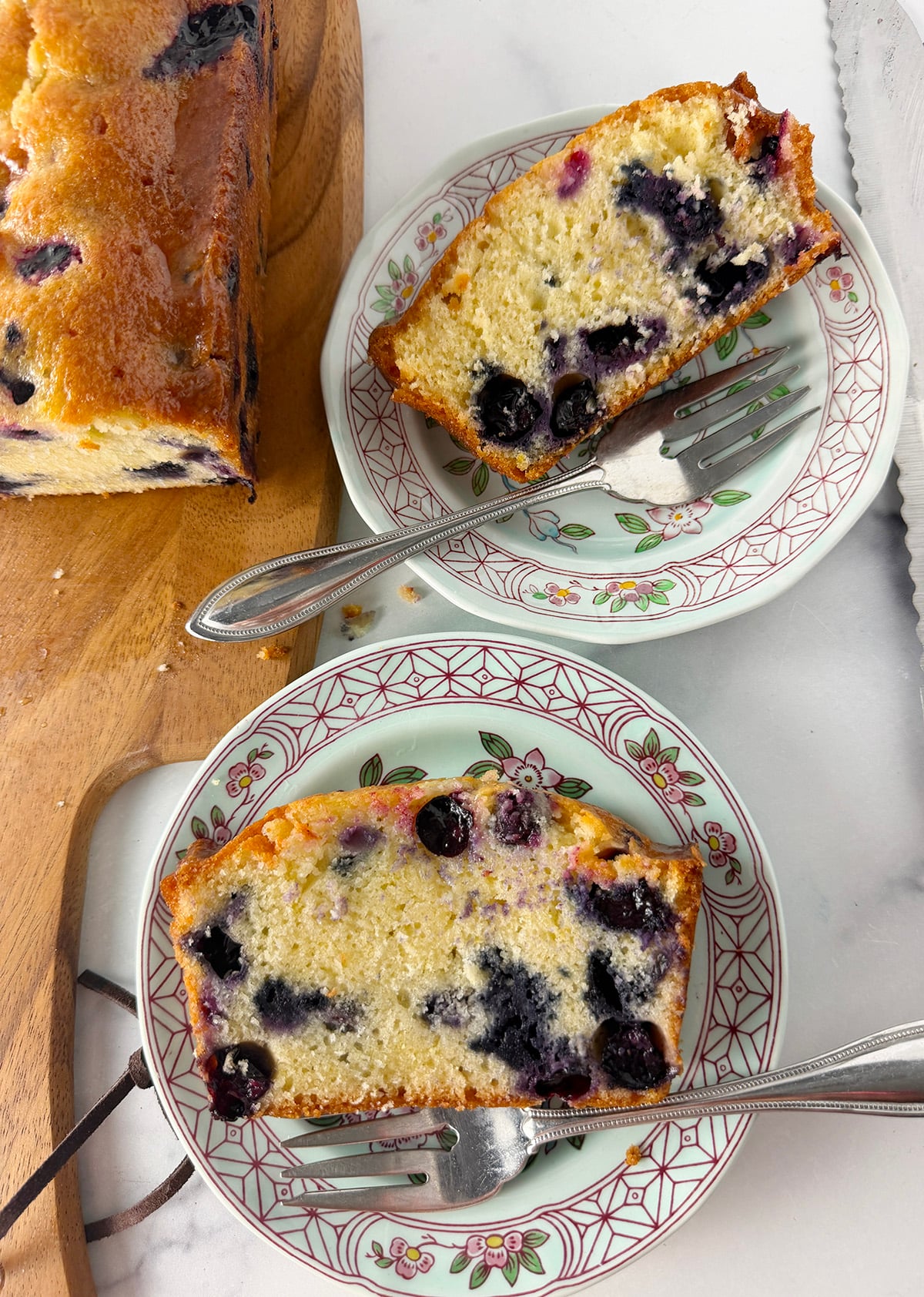 Blueberry bread served on small singapore bird china plates.