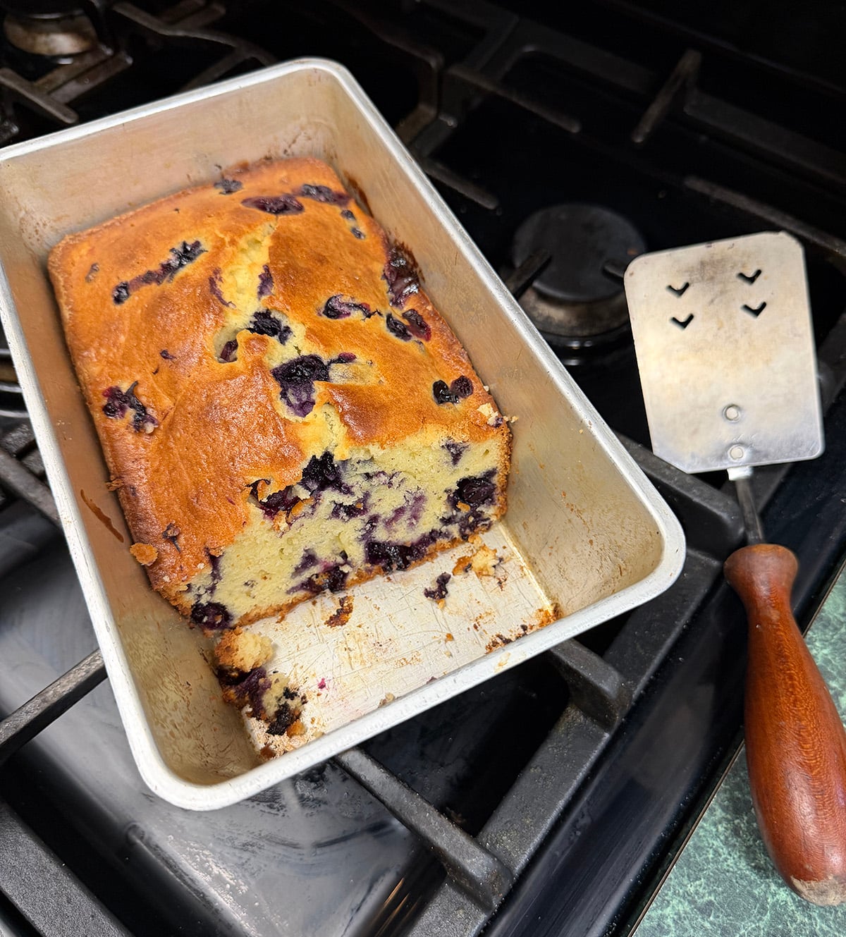 Blueberry bread in baking pan on stove.