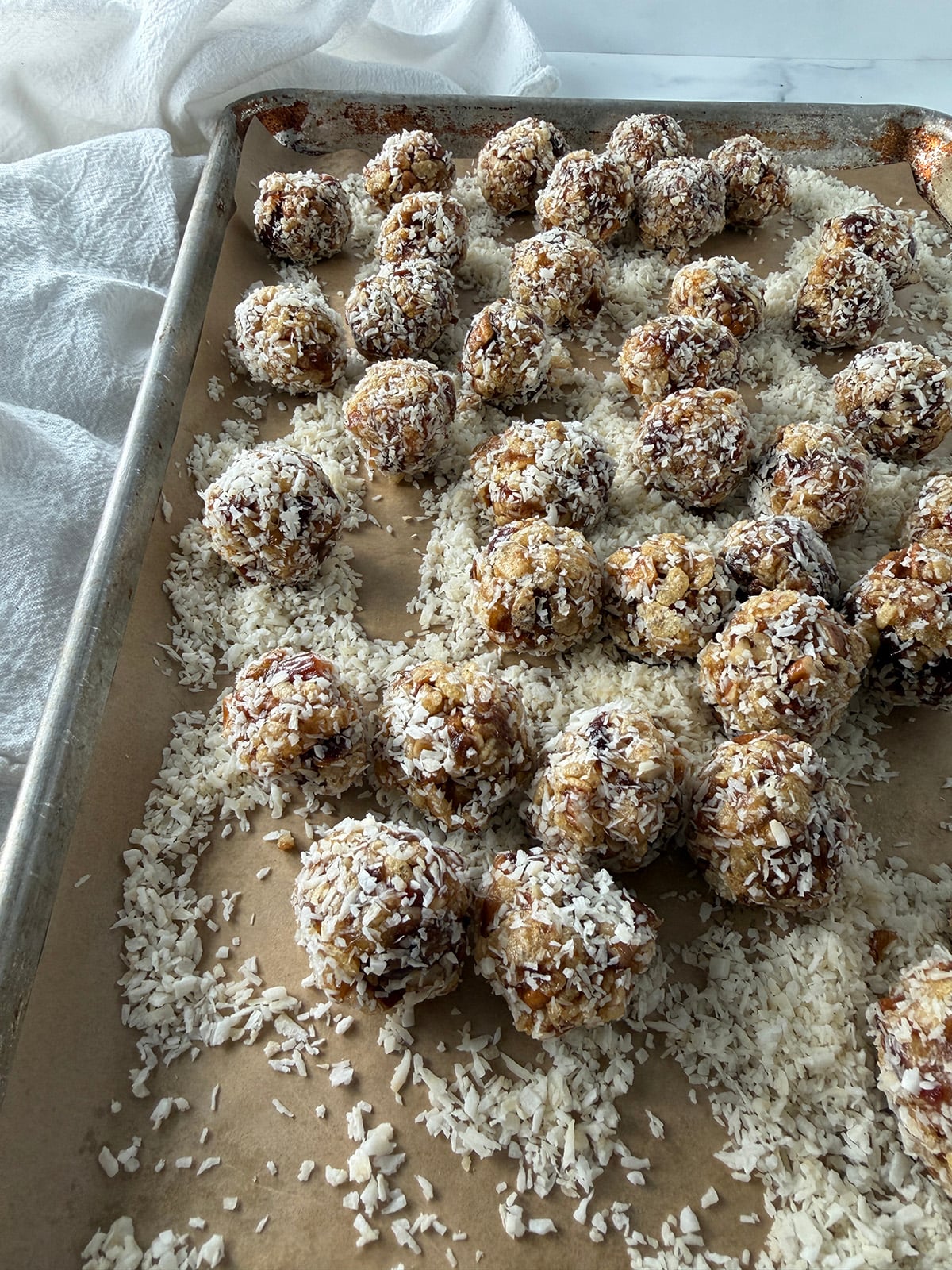 Old-fashioned date-nut balls on a sheet pan.