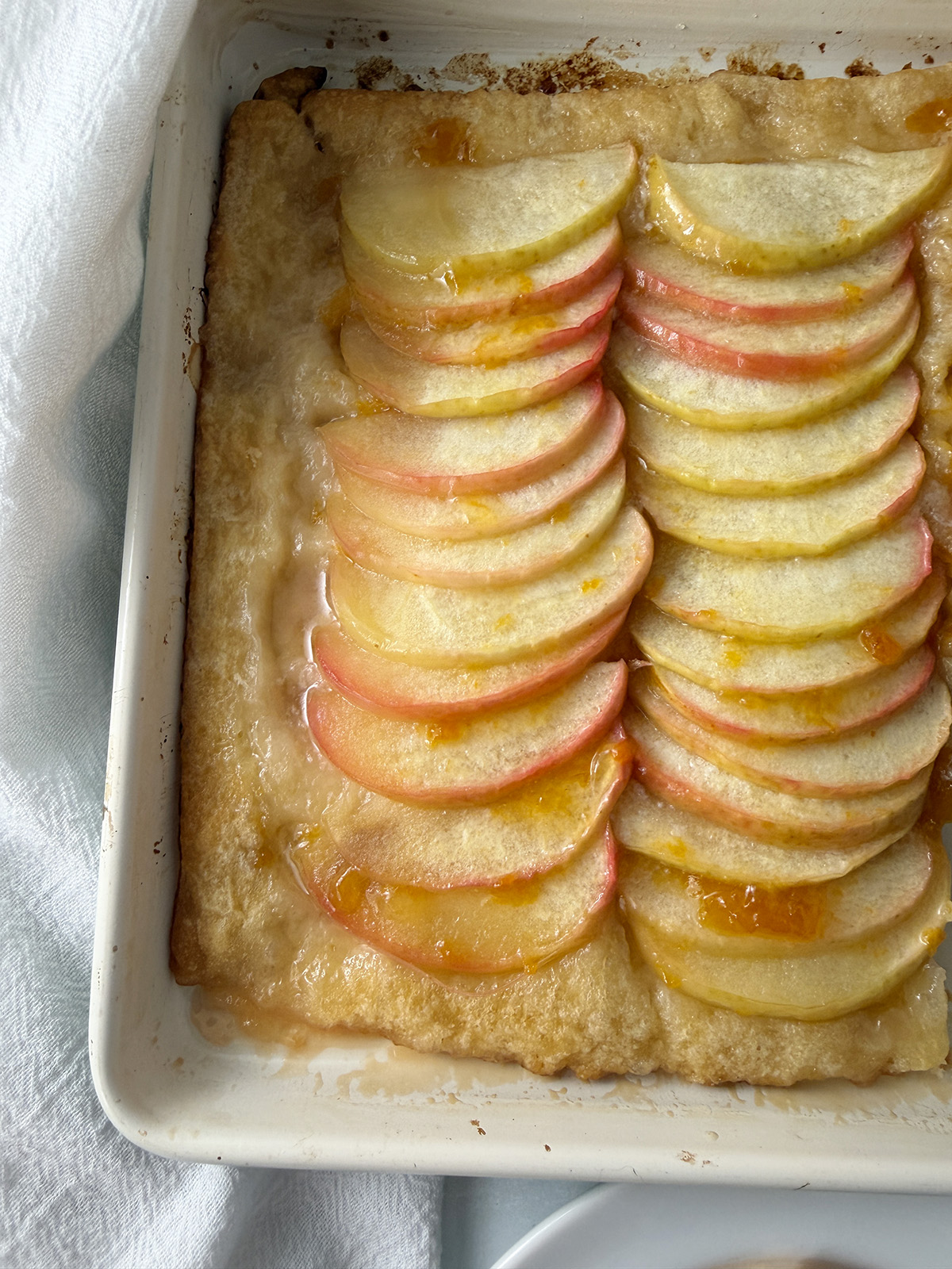 A 13x9 baking pan with baked apple tart fresh out of the oven.