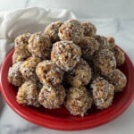 Old fashioned date nut balls on a red plate.